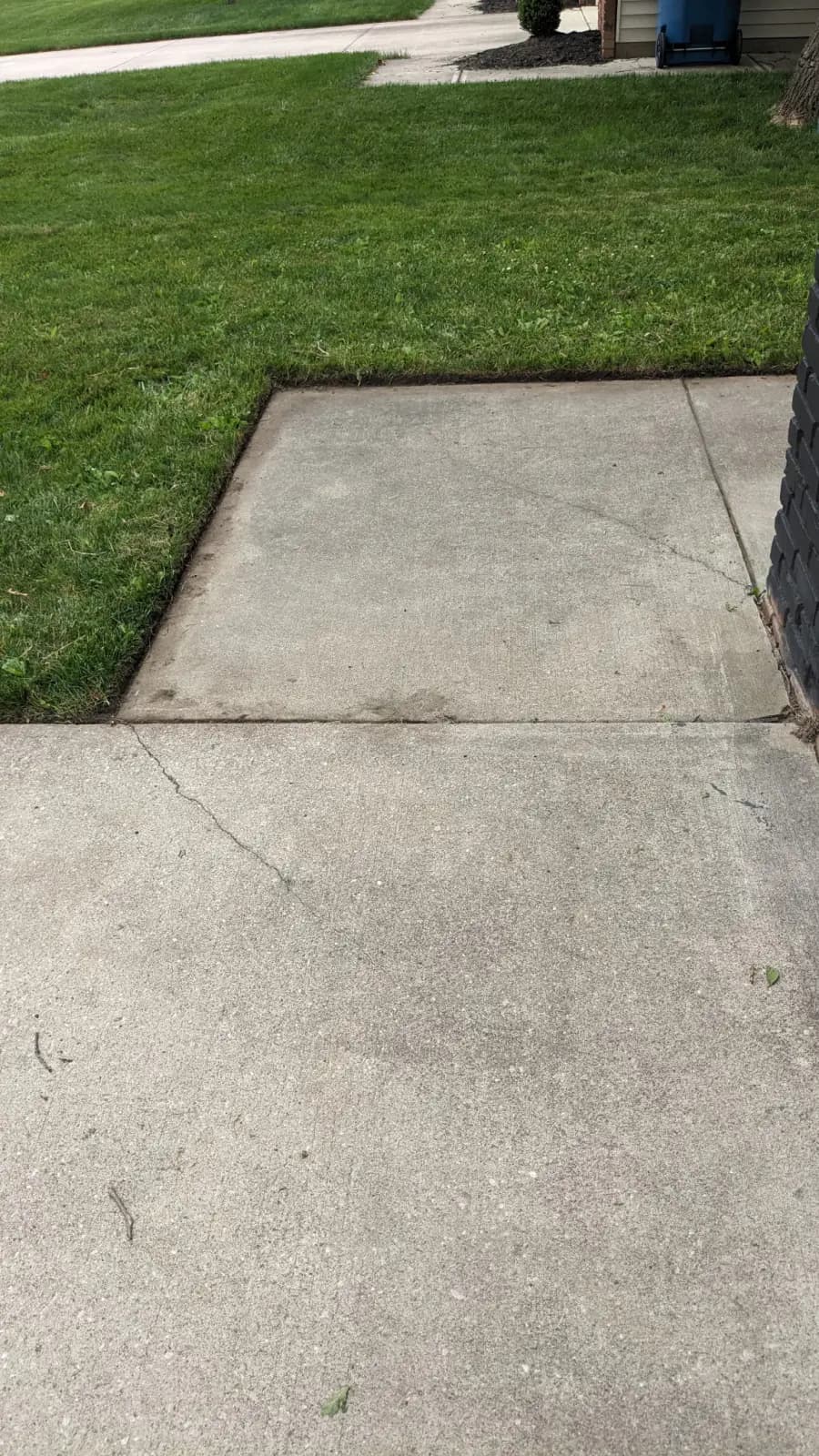 The same driveway apron after edging — a clean, sharp cut line